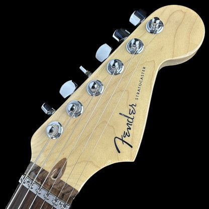 Front of headstock of Used 2006 Fender American Deluxe Stratocaster HSS Olympic White.