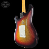 Glossy electric guitar with a sunburst finish on a black background, featuring 'Tone Shop' branding.