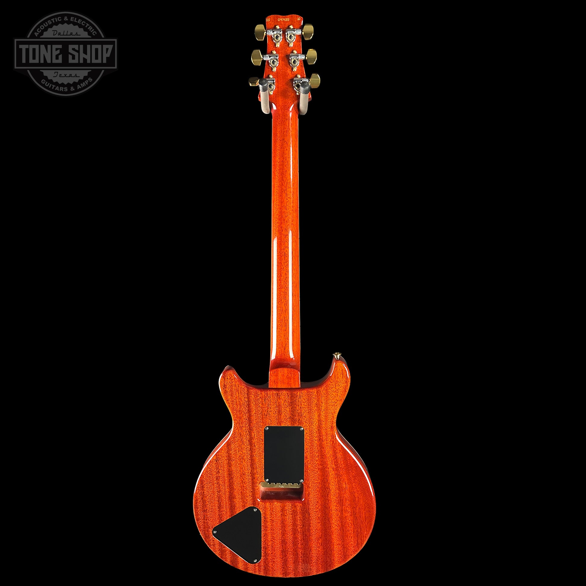 Back view of a wooden electric guitar with a visible brand logo in the corner.