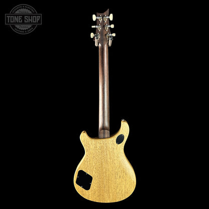 Electric guitar with a gold finish on a black background, featuring the Tone Shop logo.