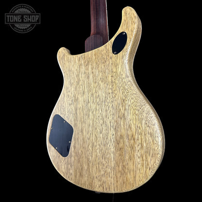 Back view of a wooden electric guitar with 'Tone Shop' logo in the corner.