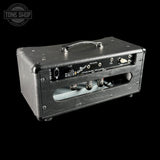 A black textured leather guitar amplifier head photographed on a solid black background, with a Tone Shop watermark in the top-left corner.