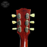 Guitar headstock with tuning pegs on a black background, featuring the Tone Shop logo.