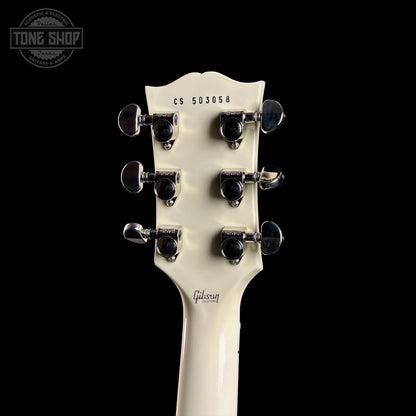Gibson guitar headstock with serial number on a black background