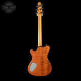 Back view of a wooden electric guitar with 'Tone Shop' logo in the corner.