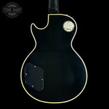 Black electric guitar body with Gibson logo on a black background