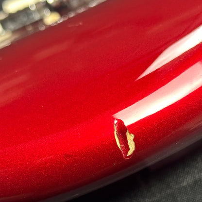 Medium dent on bottom edge of Used 1983 Fender Dan Smith Era Candy Apple Strat.