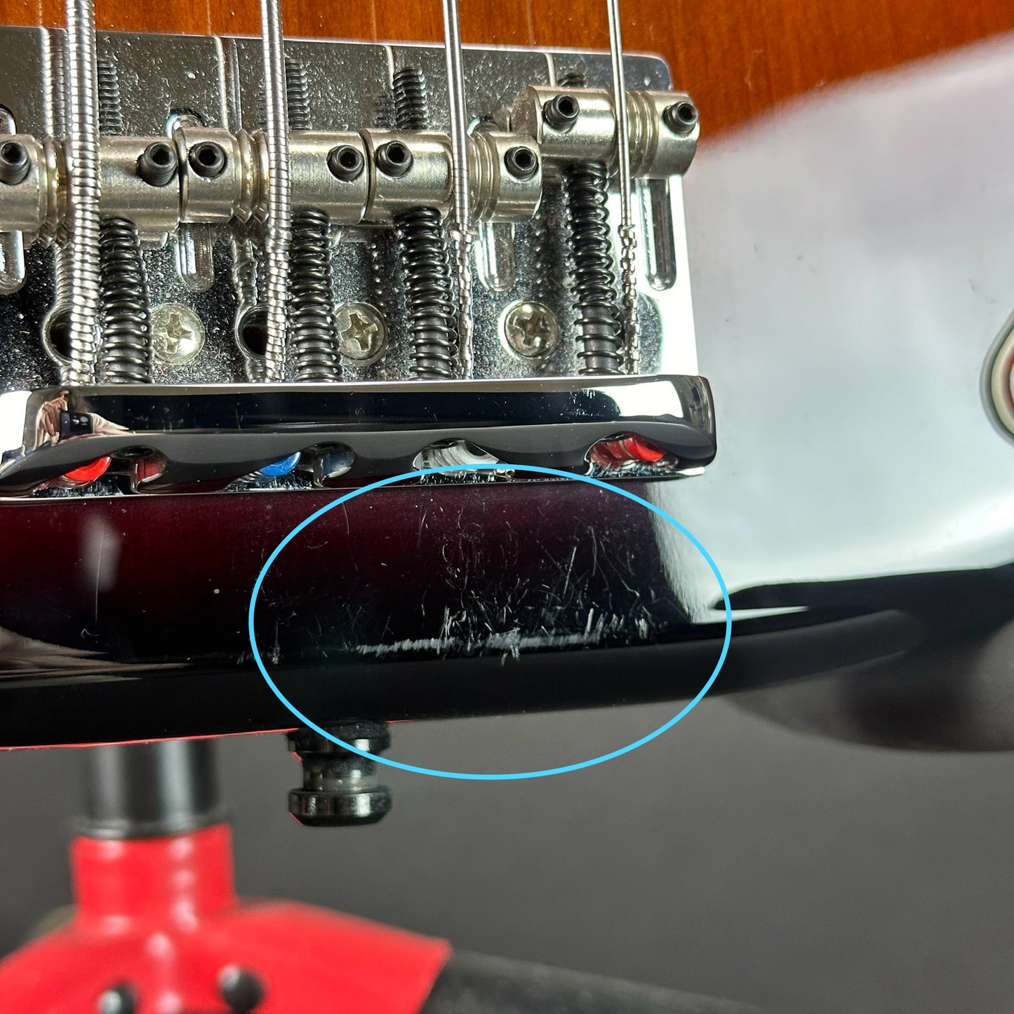 Scratches near bridge of Used 2021 Fender American Pro II Precision Bass Sunburst.