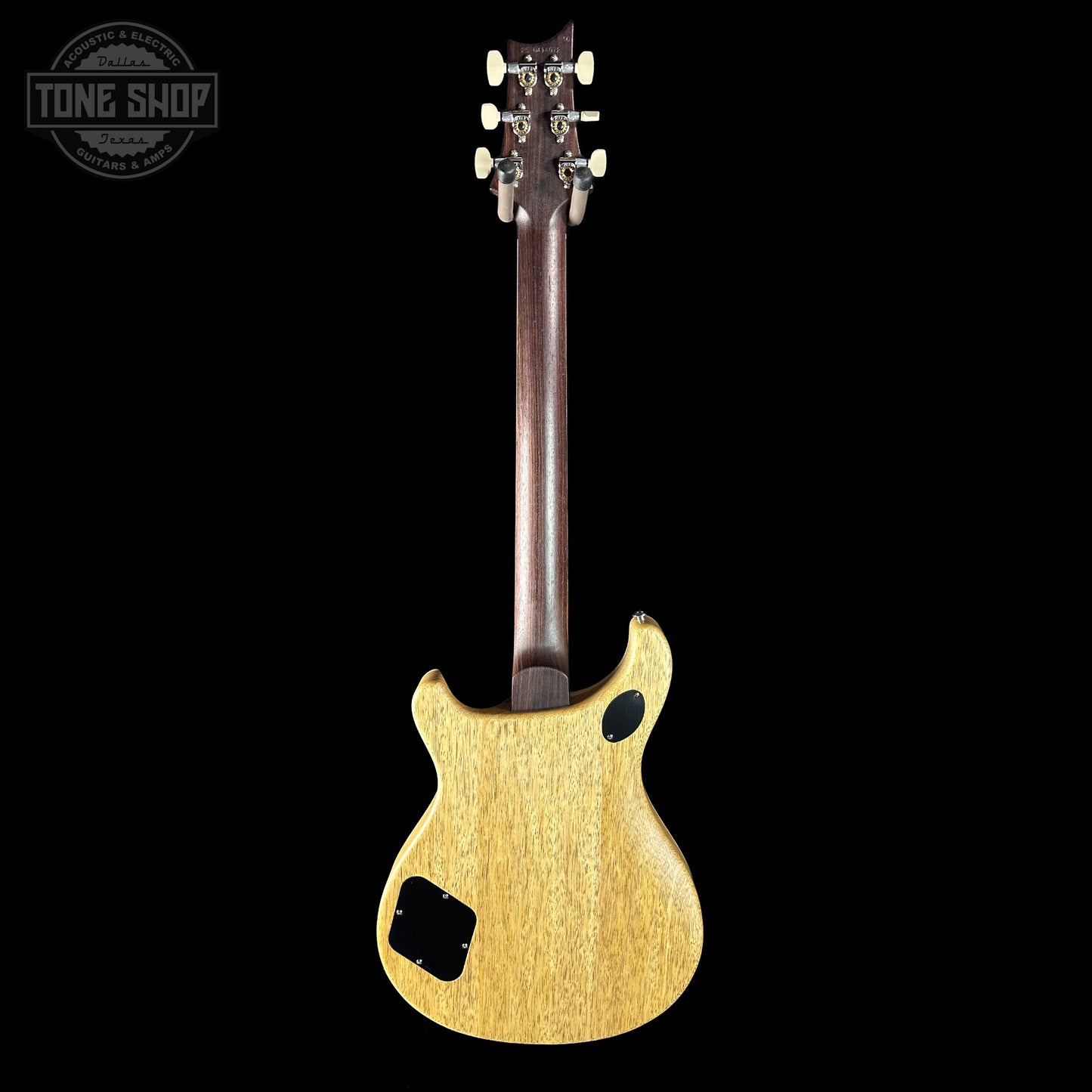 Back view of a guitar with a visible brand logo in the corner.