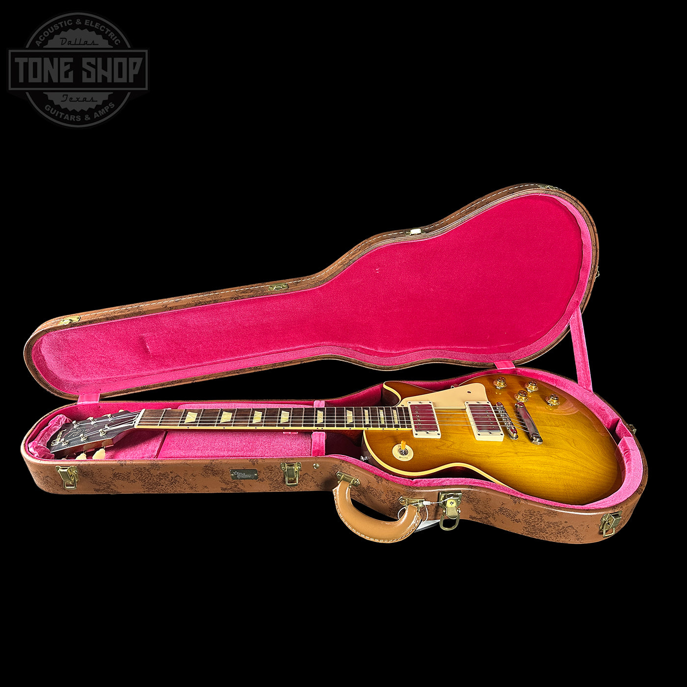 Gibson Les Paul guitar in a pink-lined case with 'Tone Shop' logo.
