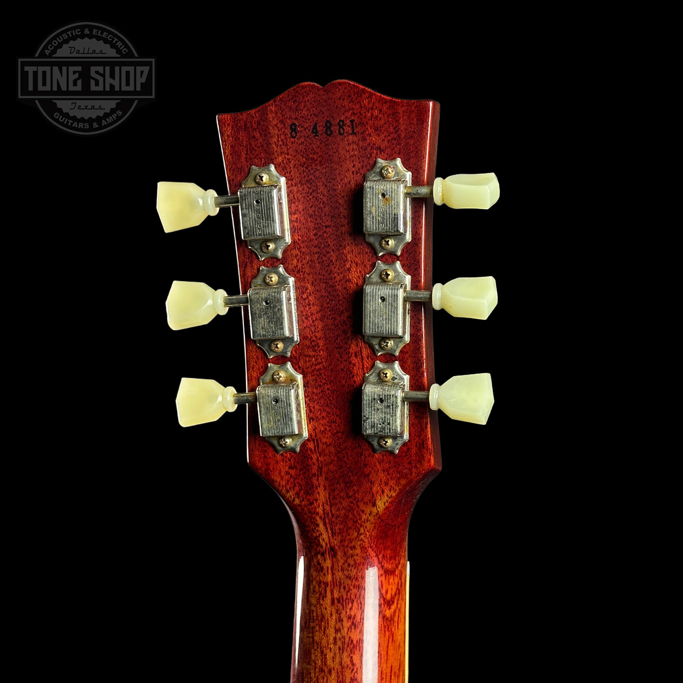 Guitar headstock with tuning pegs on a black background, featuring 'Tone Shop' logo.
