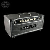 A Matchless guitar amplifier head in textured black leather, shown at a three-quarter angle against a solid black background. The front features cream-colored control knobs and a black brand plate with white lettering.