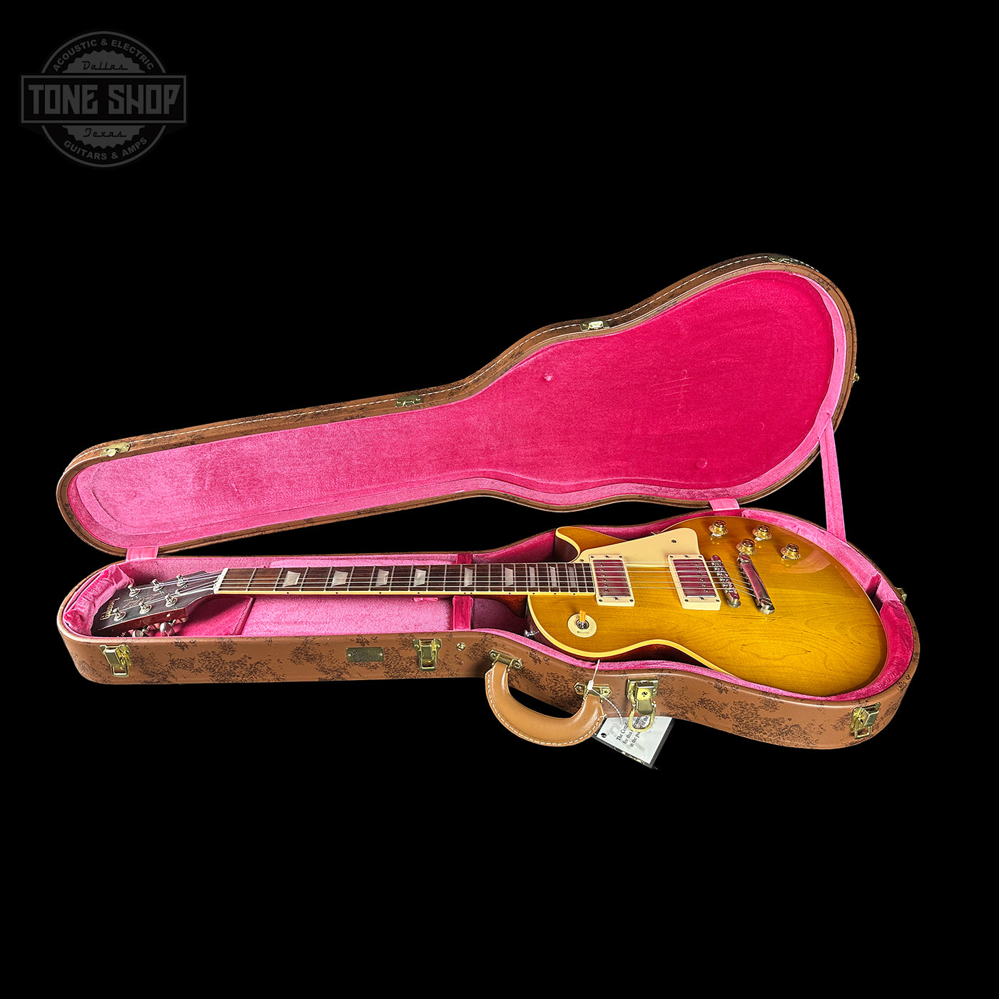 Gibson Les Paul guitar in a pink case with 'Tone Shop' logo.