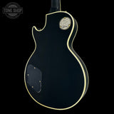 Gibson electric guitar body on a black background with 'Tone Shop' logo.