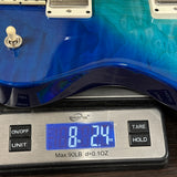 Blue electric guitar on a digital scale displaying weight.
