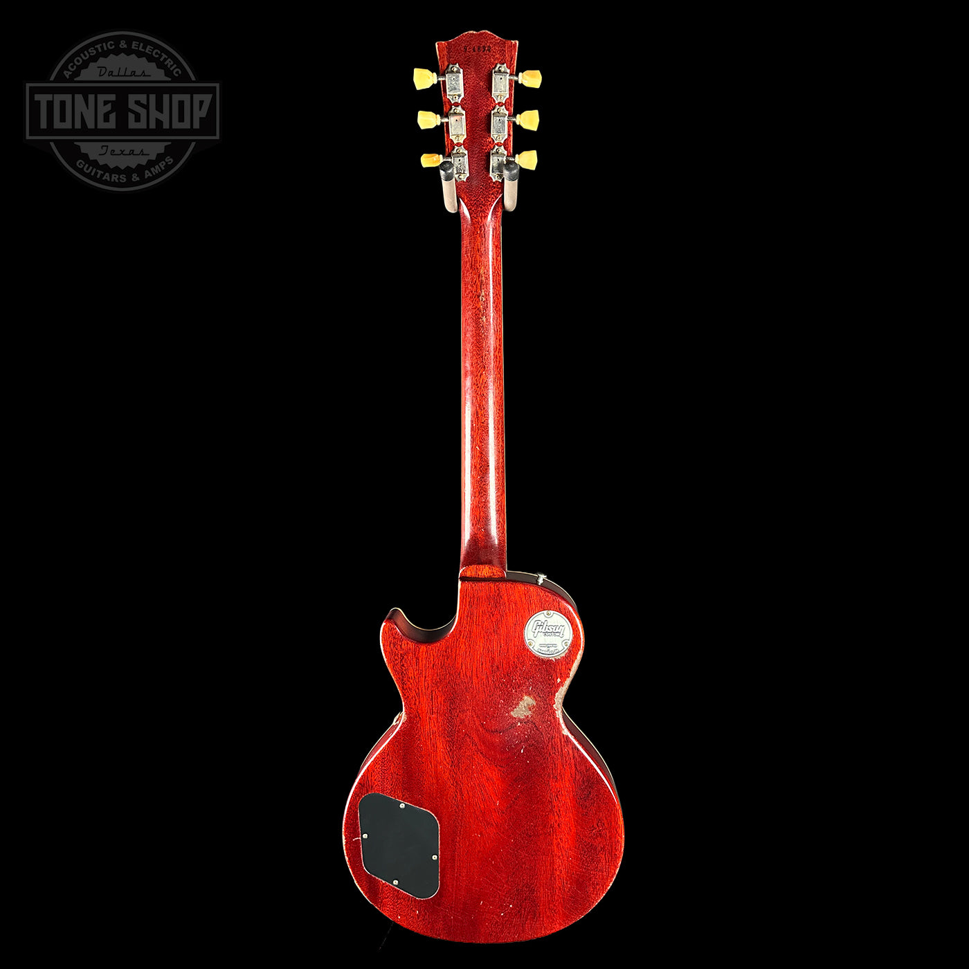 Red electric guitar on a black background with 'Tone Shop' logo.