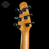 Close-up of a guitar headstock with tuning pegs on a black background, featuring the Tone Shop logo.
