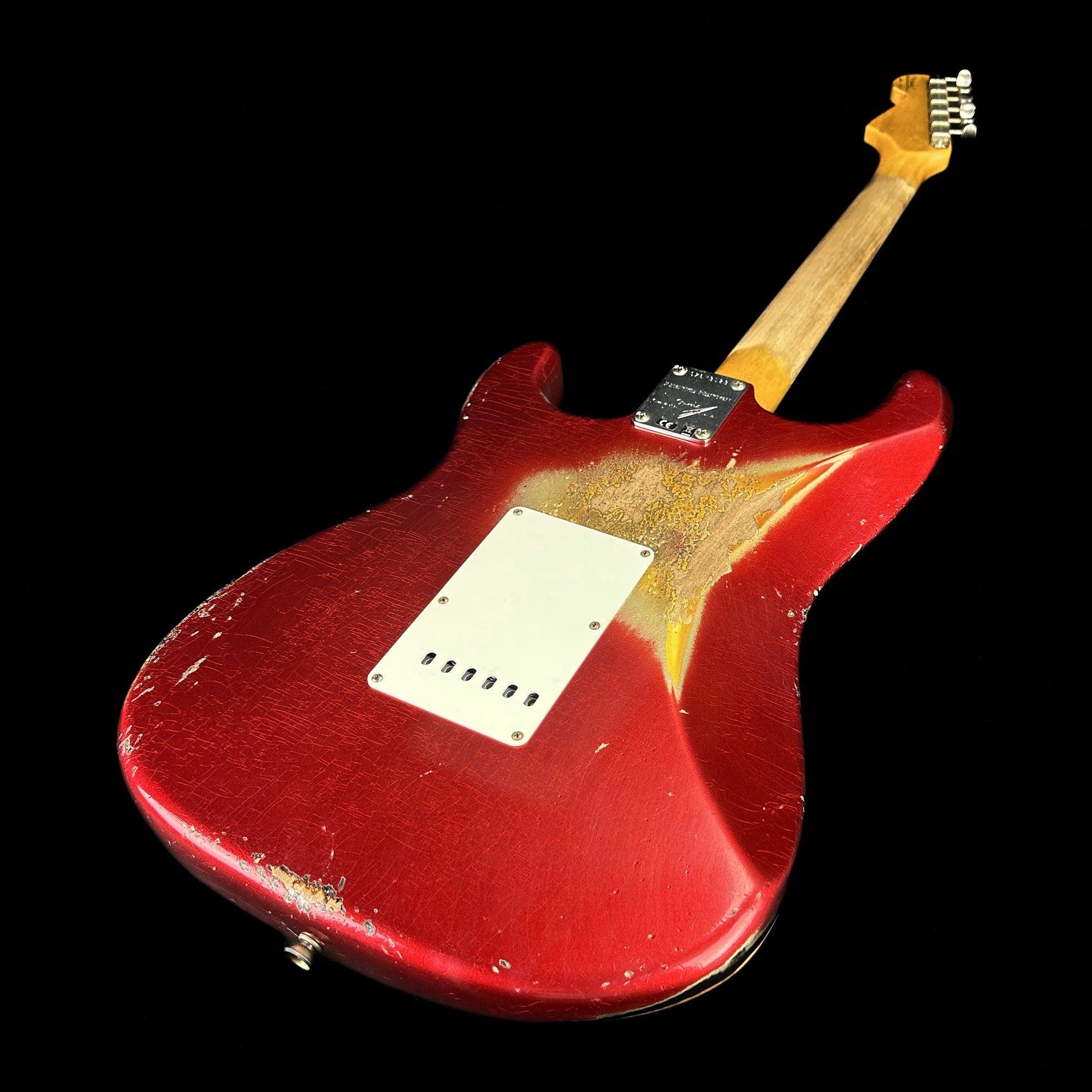 Back angle of Fender Custom Shop Limited Edition '62 Strat Heavy Relic Aged Candy Apple Red Over 3 Color Sunburst.