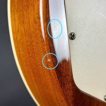 Small ding and scratch on back edge of Used Epiphone Les Paul Flame Top Standard Sunburst.