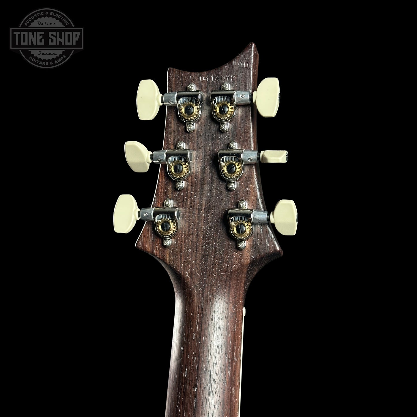 Guitar headstock with tuning pegs on a black background, featuring the Tone Shop logo.