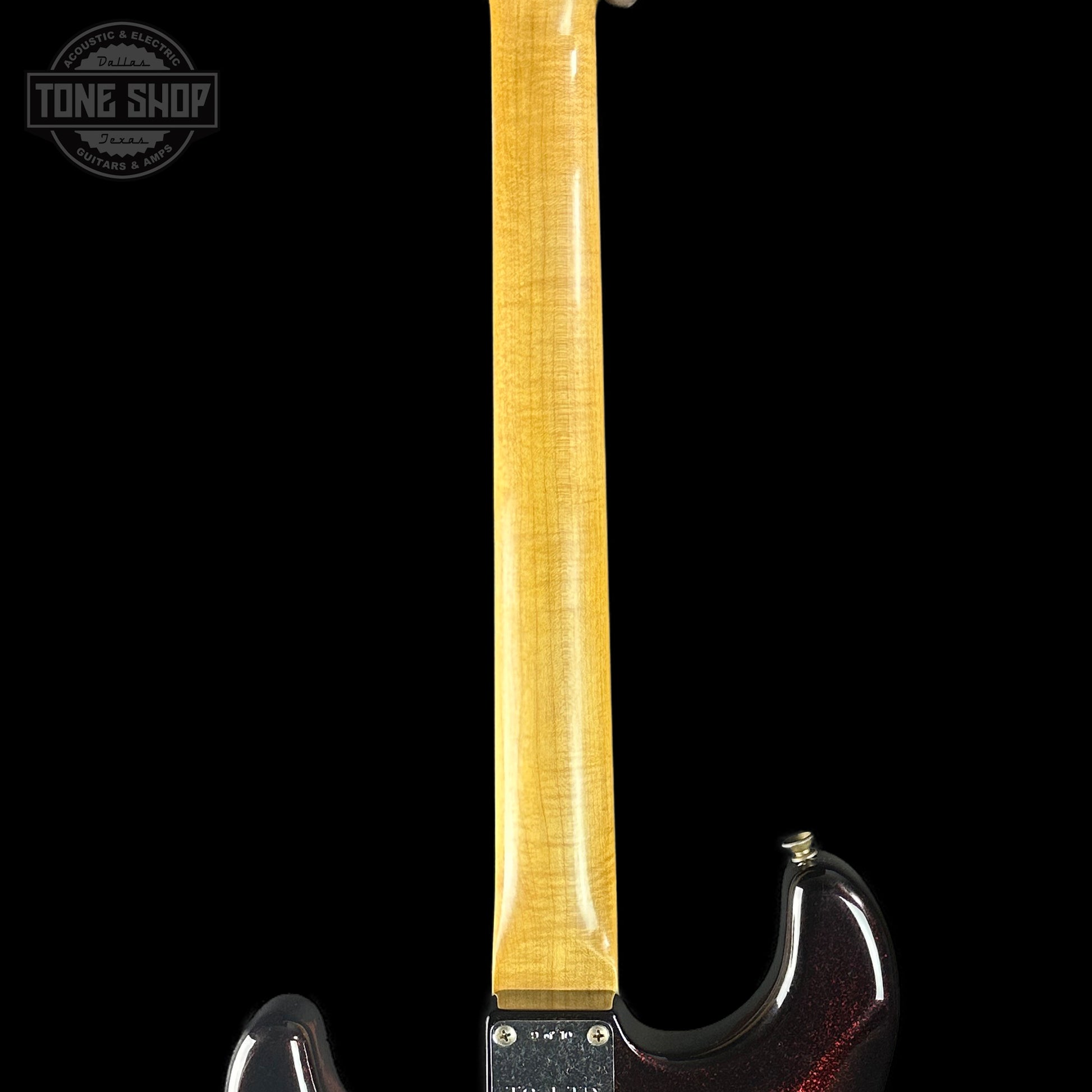 Guitar neck with a black body on a white background, featuring the Tone Shop logo.