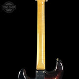 Guitar neck and headstock with a dark body on a black background, featuring 'Tone Shop' branding.