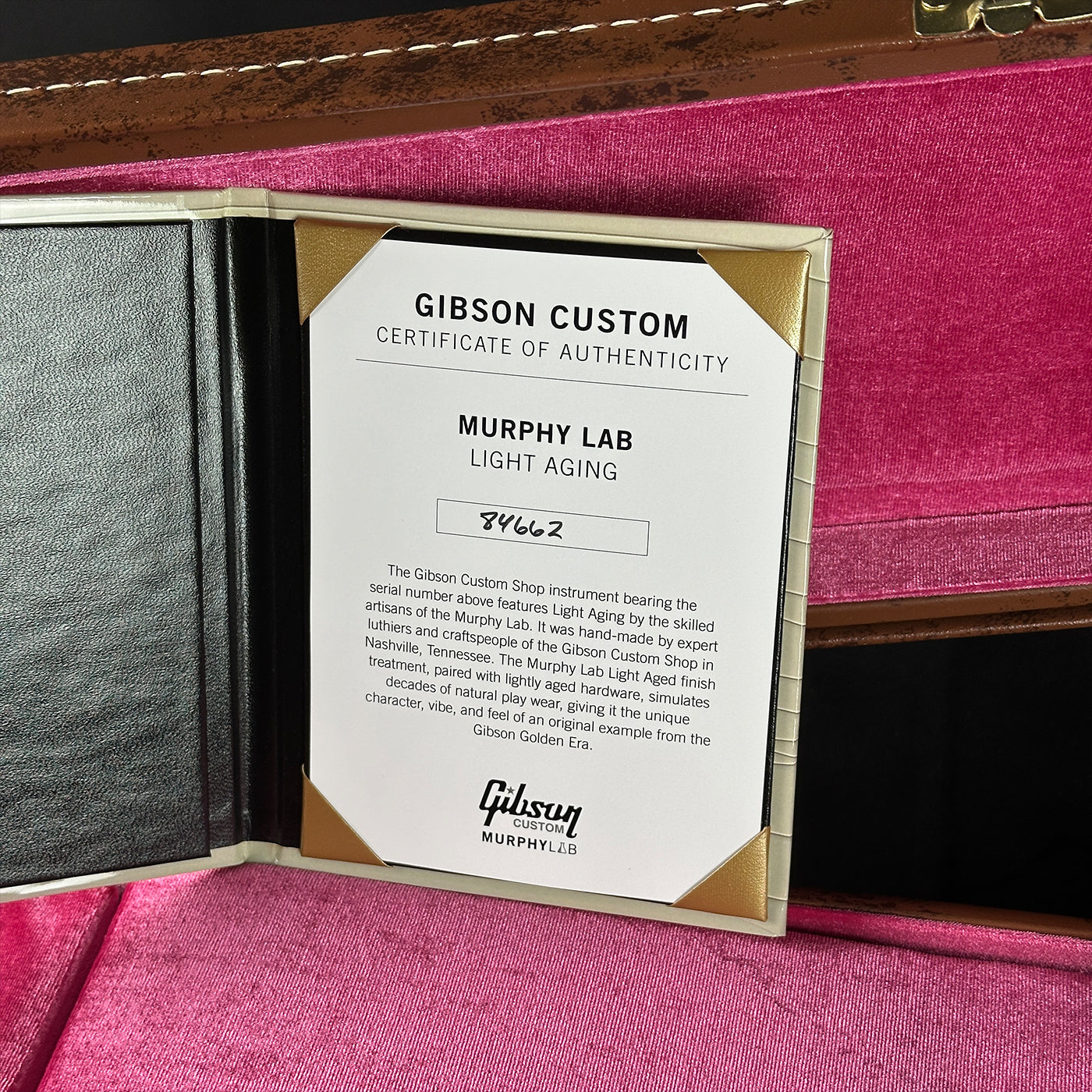 Gibson Custom Certificate of Authenticity on a pink surface