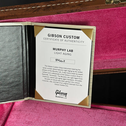 Gibson Custom Certificate of Authenticity on a pink surface