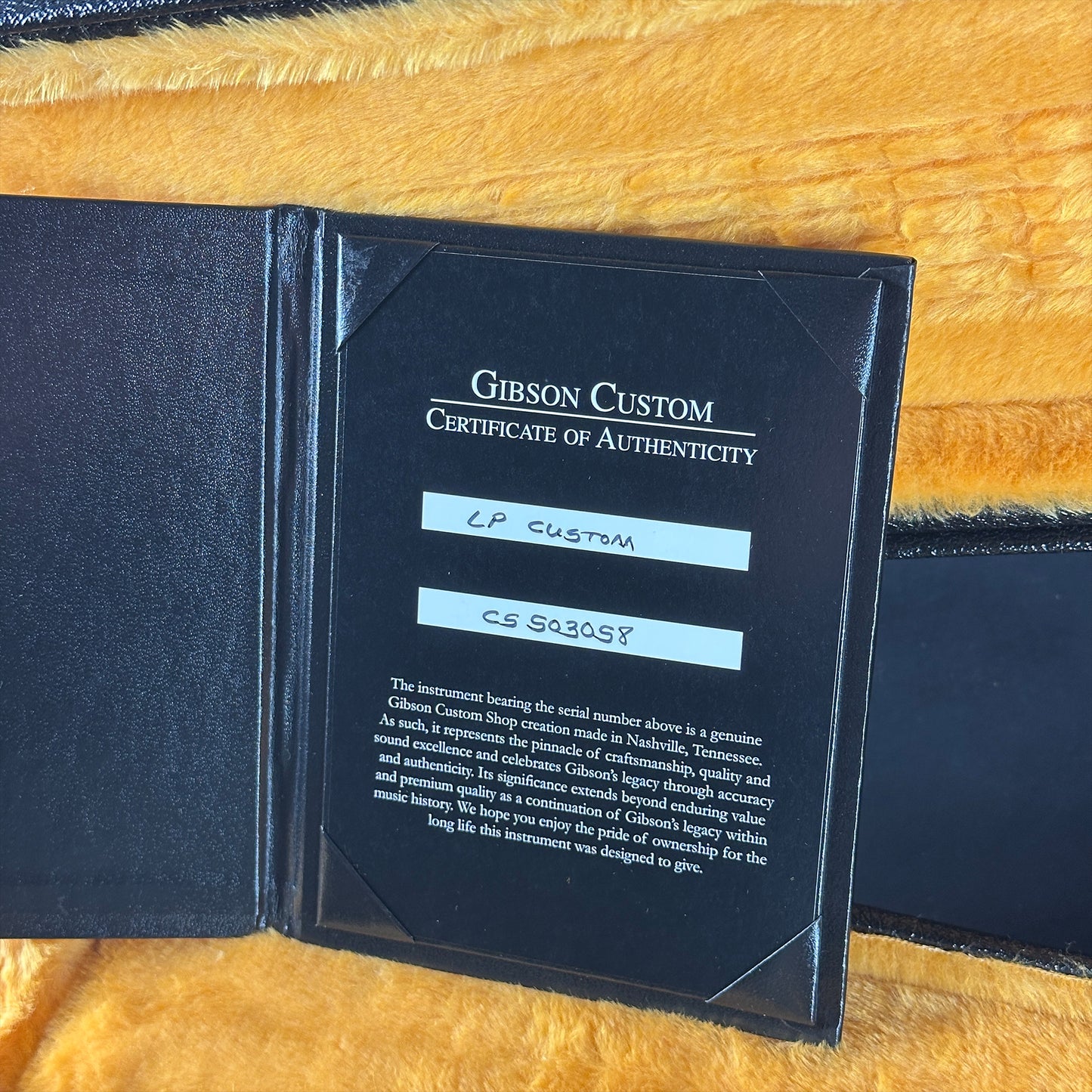 Gibson Custom Certificate of Authenticity on a yellow textured background