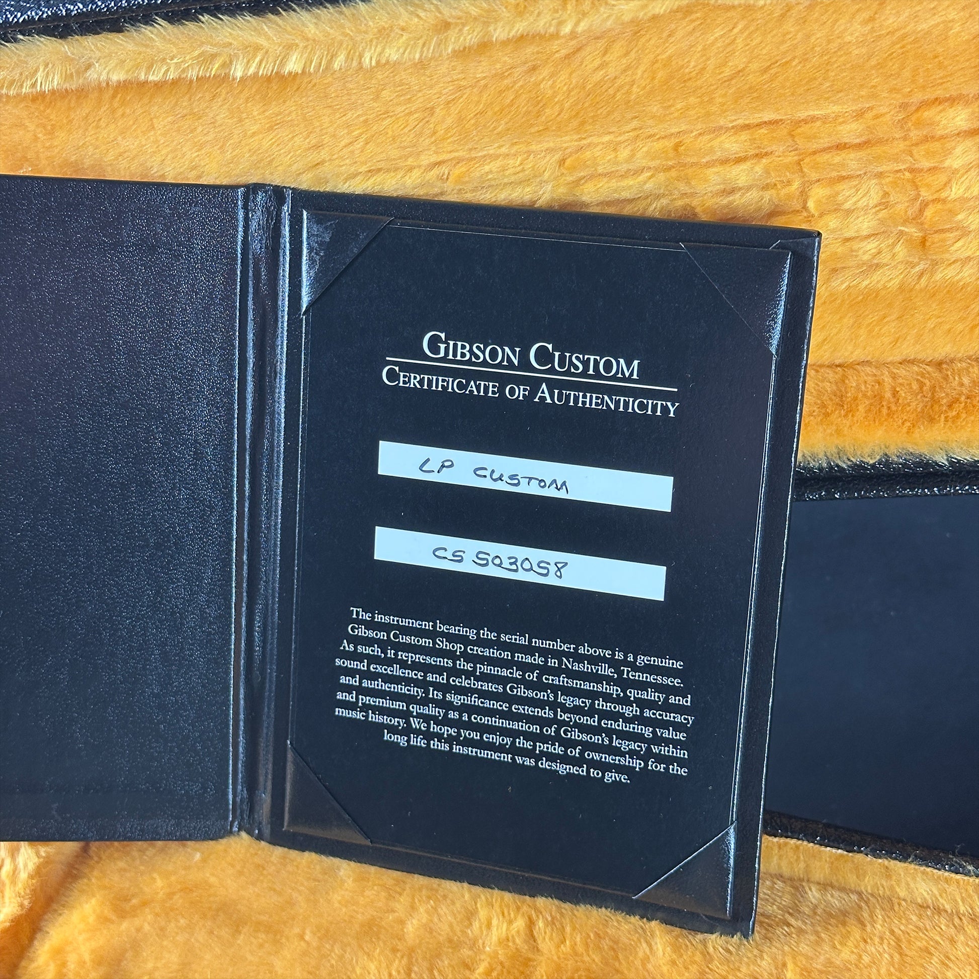 Gibson Custom Certificate of Authenticity on a yellow textured background