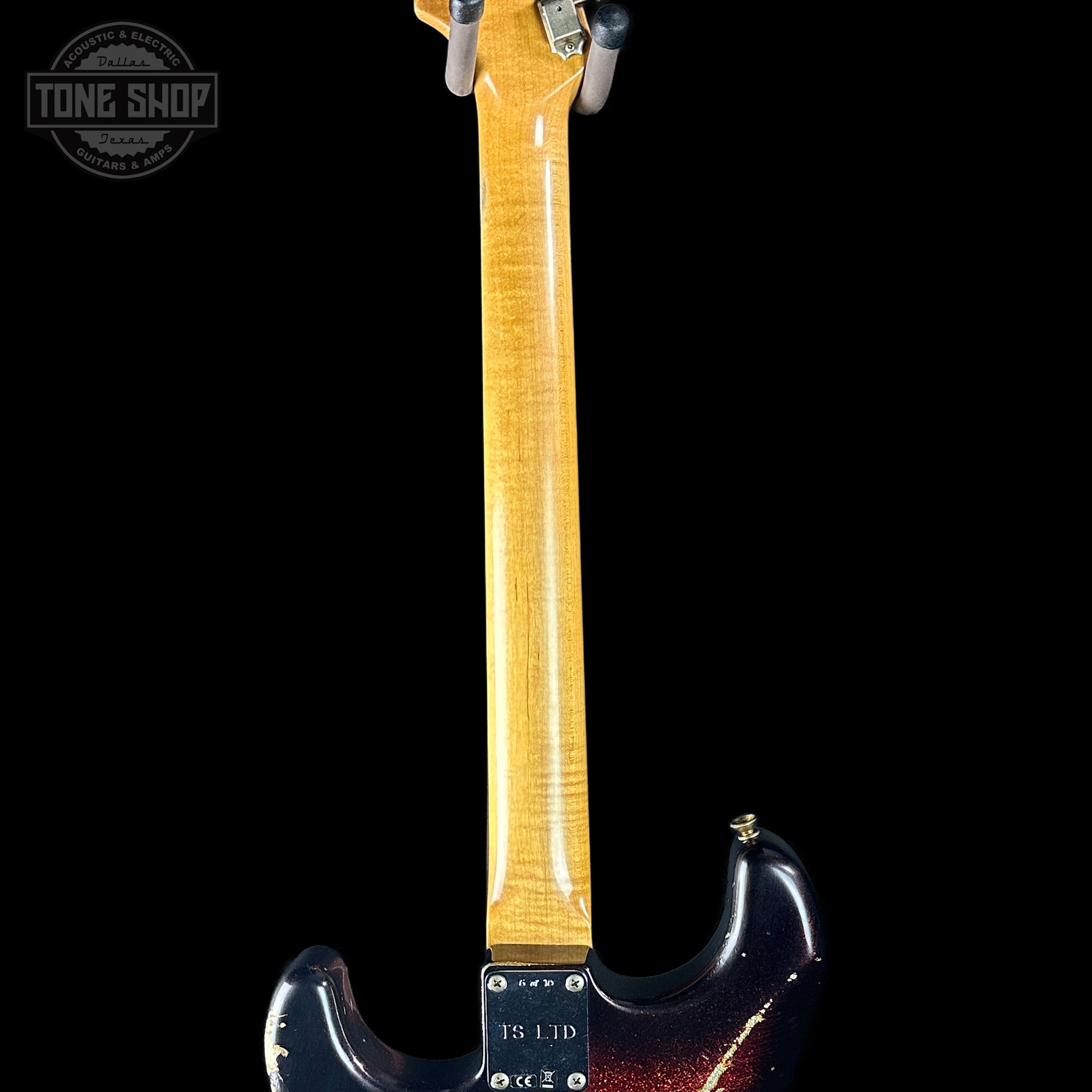 Guitar neck with a 'Tone Shop' logo in the corner