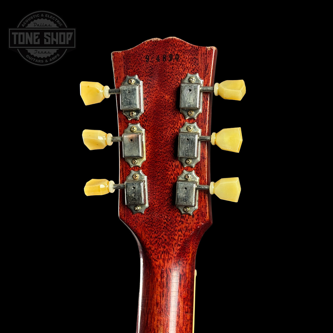 Guitar headstock with tuning pegs on a black background, featuring 'Tone Shop' branding.