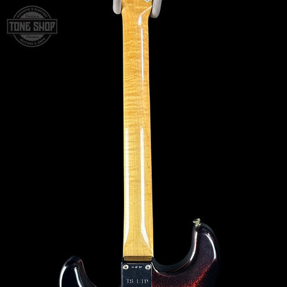 Guitar neck with a visible brand logo on a black background