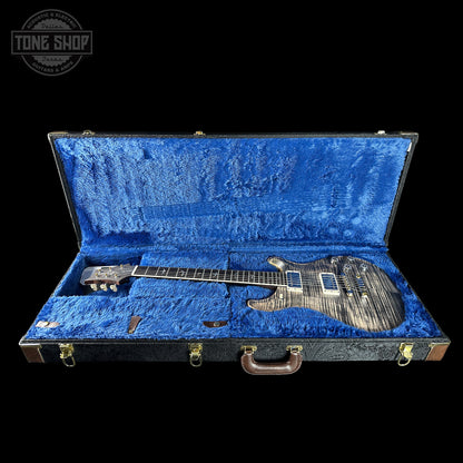 Guitar in a blue case with 'Tone Shop' logo in the corner