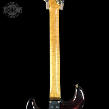 Guitar neck with a visible brand logo on a black background