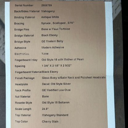 Cardboard label with detailed specifications of a guitar on a gray background