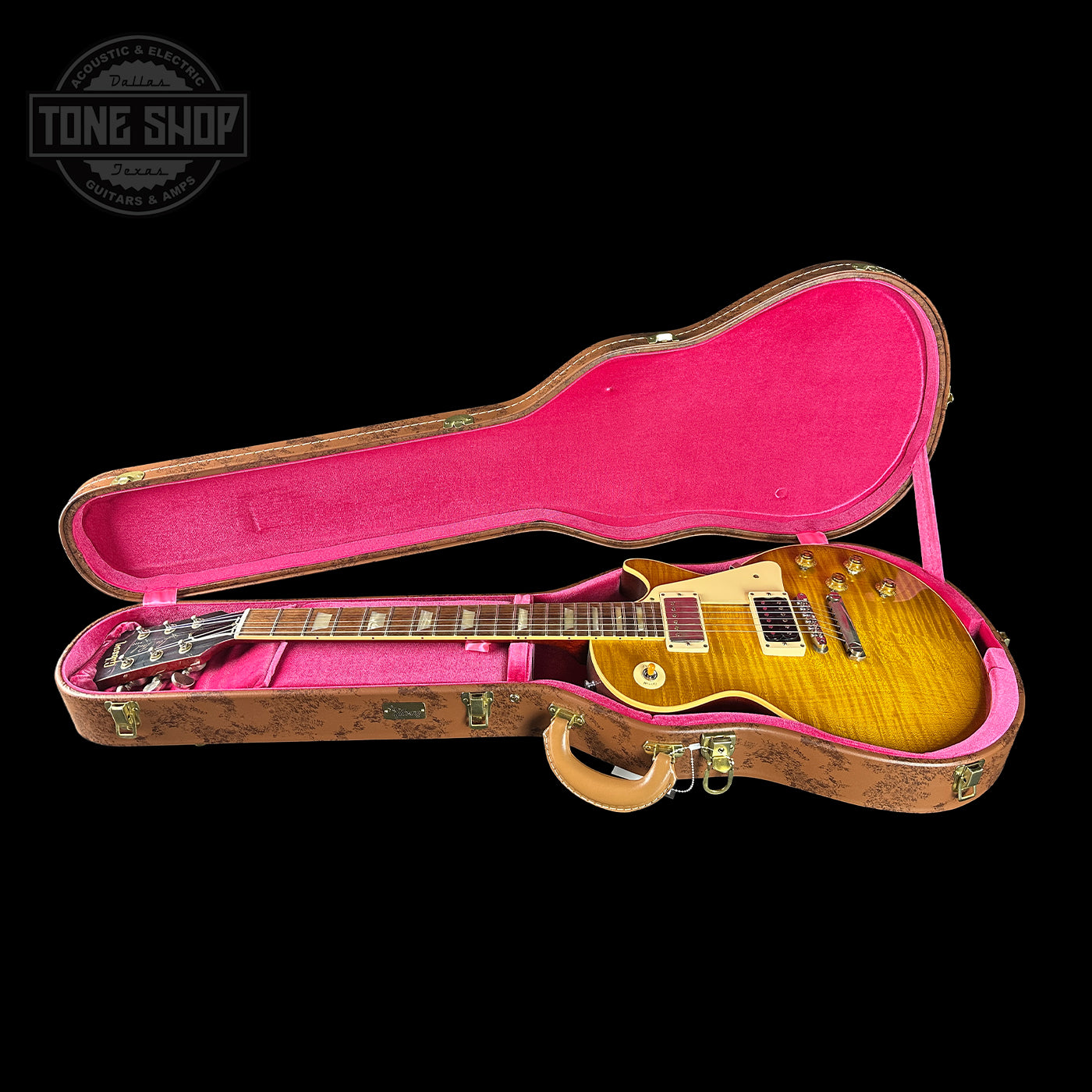 Gibson Les Paul guitar in a pink-lined case with 'Tone Shop' logo.
