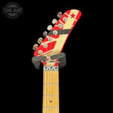 Guitar headstock with red and white design on a black background, featuring 'Tone Shop' logo.