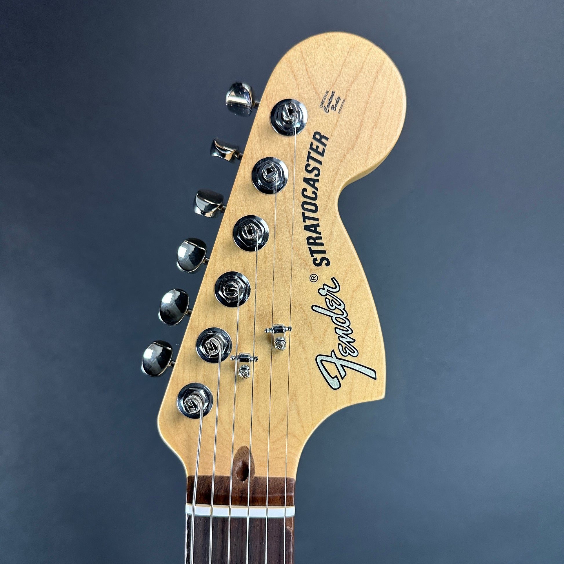 Front of headstock of Used Fender American Performer Stratocaster RW Honey Burst.