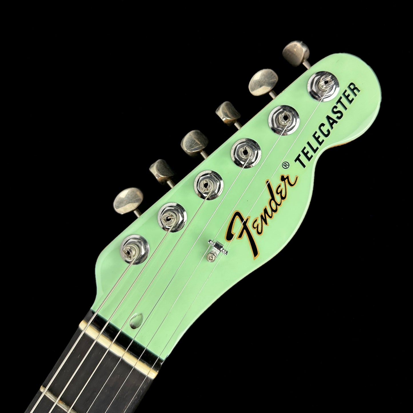 Front of headstock of Used Fender Limited Two Tone Telecaster Thinline Seafoam Green.