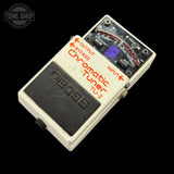 Boss TU-2 Chromatic Tuner pedal on a black background with 'Tone Shop' logo.