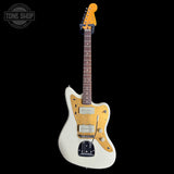 Squier J Mascis Jazzmaster Olympic White electric guitar with a distinctive body design on a black background, featuring 'Tone Shop' branding.