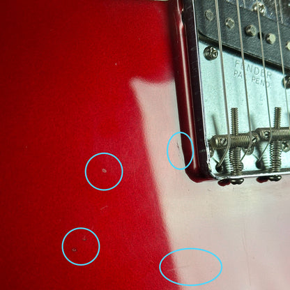 Marks near bridge of Used 2000 Fender Custom Shop 63 Telecaster NOS Candy Apple Red.