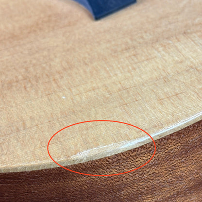 Damage on bottom edge of Used Taylor Baby Taylor.