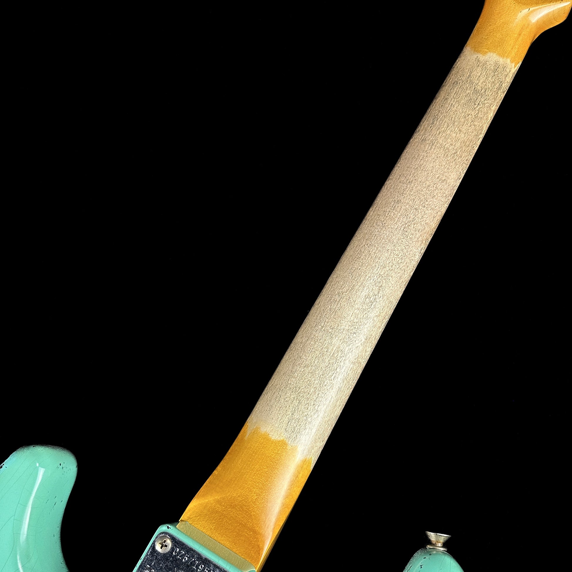 Back of neck of Fender Custom Shop Limited Edition '62 Strat Heavy Relic Faded Aged Sea Foam Green Over 3 Color Sunburst.