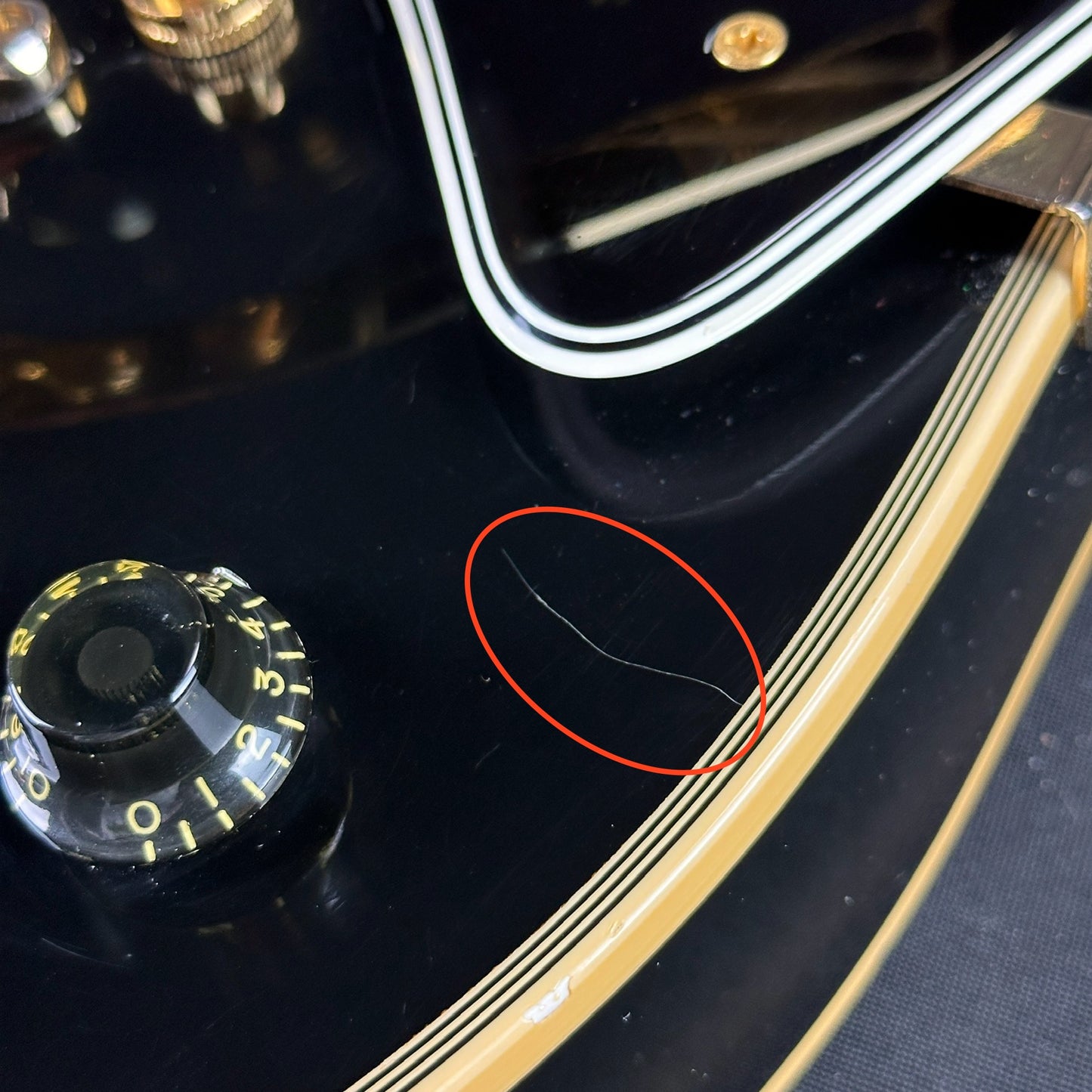 Scratch near controls of Used Gibson Custom Shop 57 Les Paul Custom 3 Pickup Bigsby.