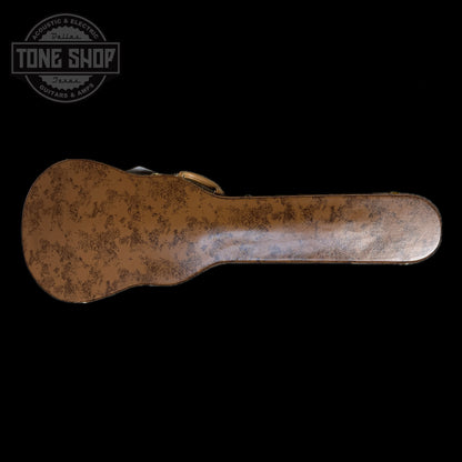 Rust-colored guitar case on a black background with 'Tone Shop' logo.