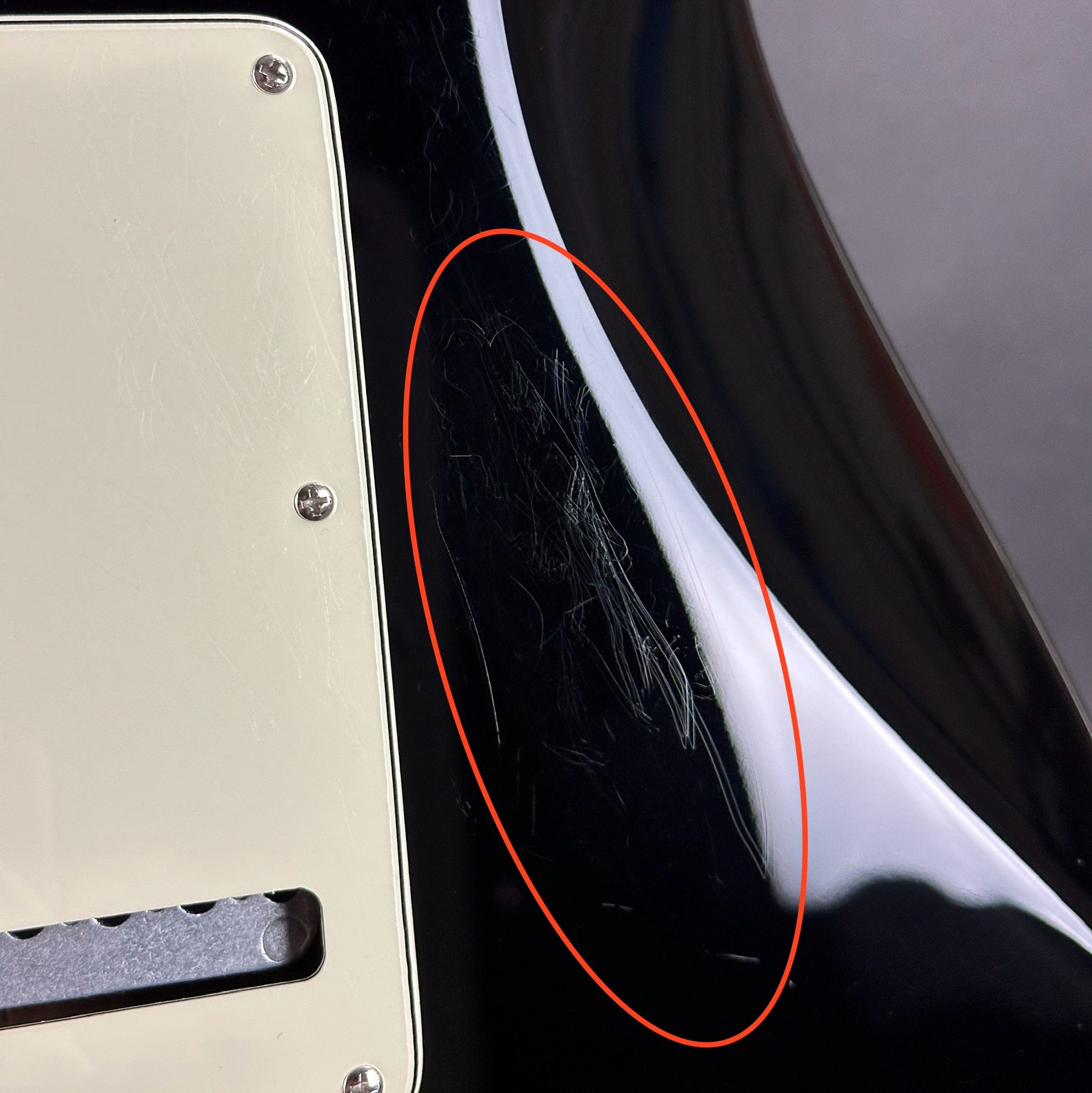 Scratches near backplate of Used Fender Special Edition Player Strat Black.