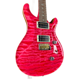 Pink electric guitar with a white background