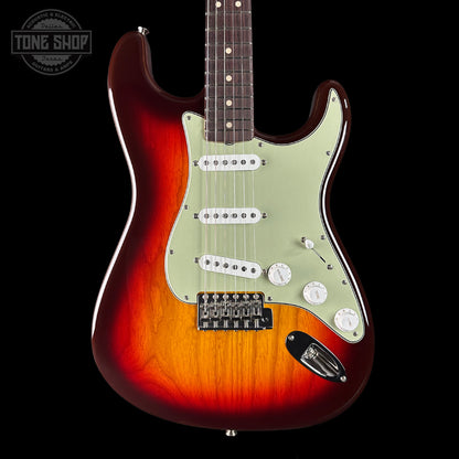 Electric guitar with a sunburst finish on a black background, featuring the Tone Shop logo.